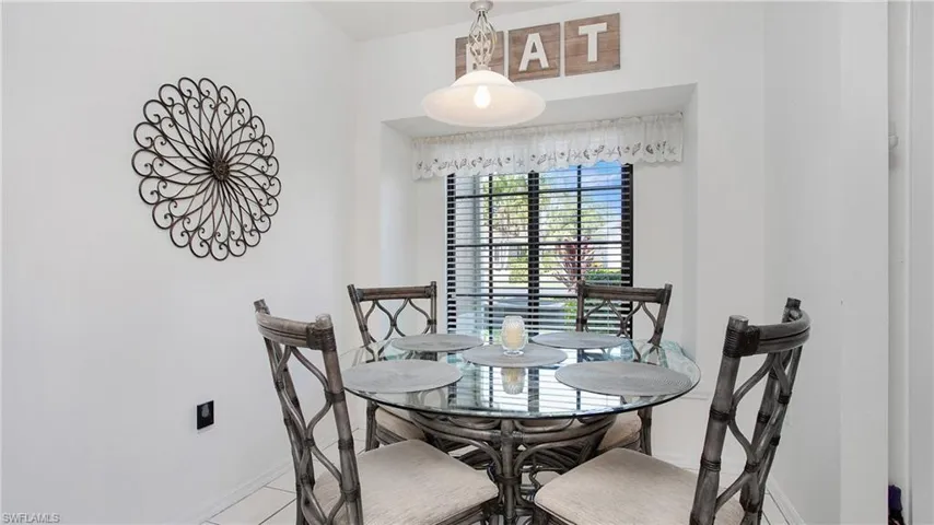 Tiled dining space with baseboards