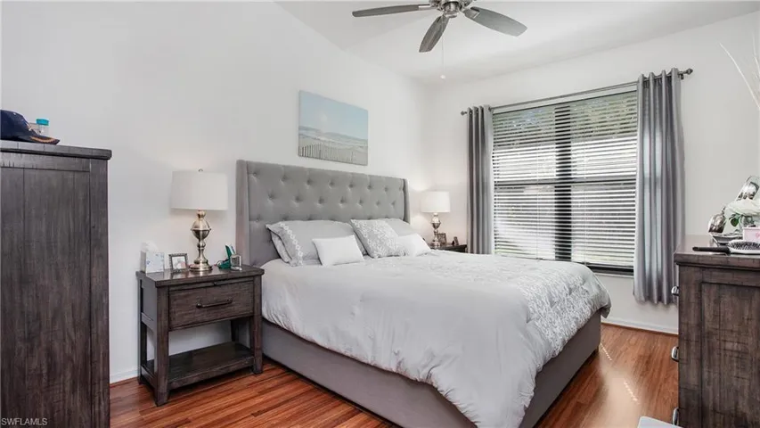 Primary Bedroom with wood finished floors and ceiling fan