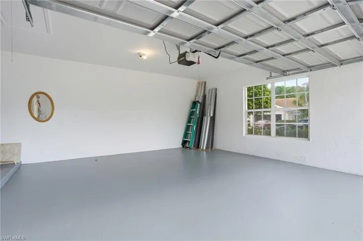 Garage with a textured wall and a garage door opener