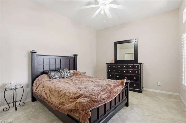 Bedroom featuring a ceiling fan and light tile patterned flooring