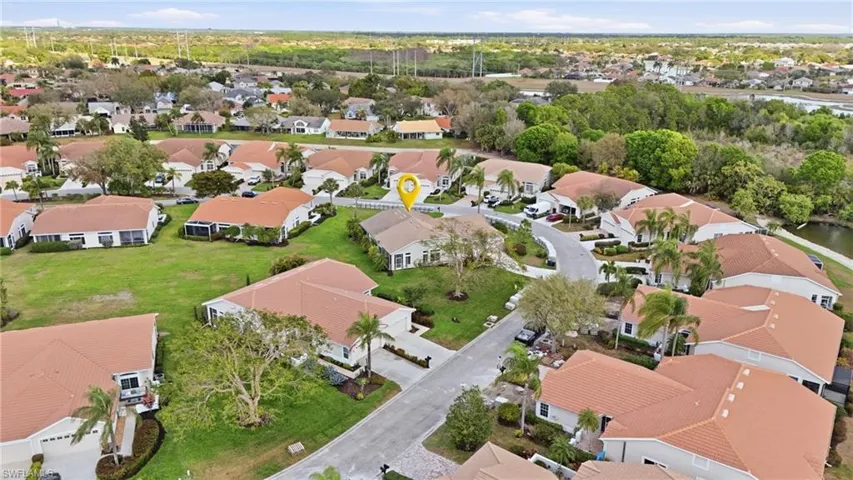 Aerial view of property and surrounding area featuring nearby suburban area