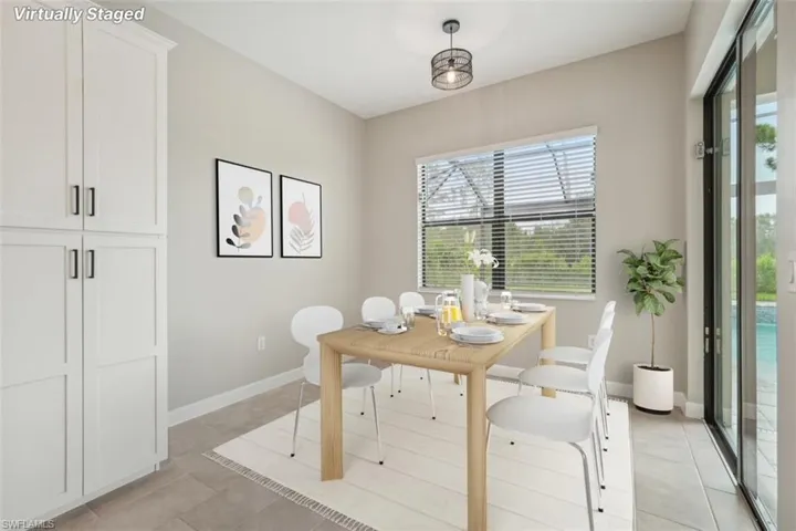 Dining space featuring light tile patterned flooring and baseboards