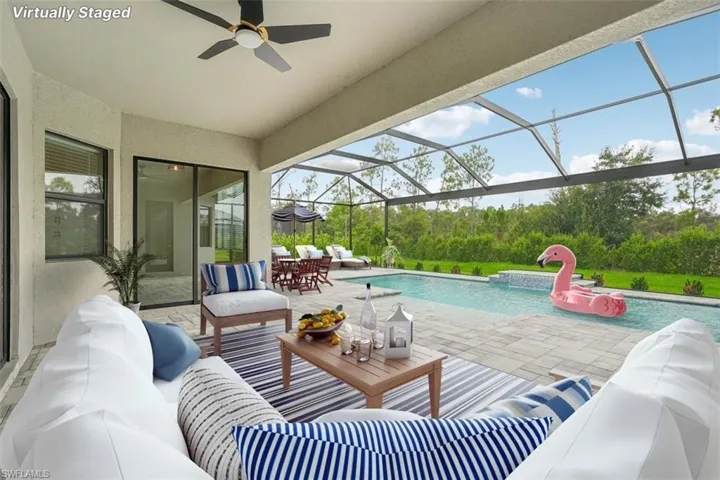 Swimming pool with an outdoor hangout area, a patio, a sunroom, a ceiling fan, and a lanai
