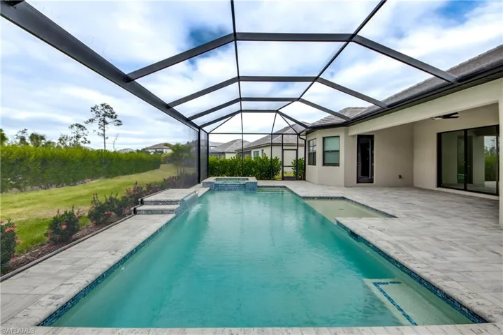 View of swimming pool with a patio, a sunroom, glass enclosure, and a pool with connected hot tub