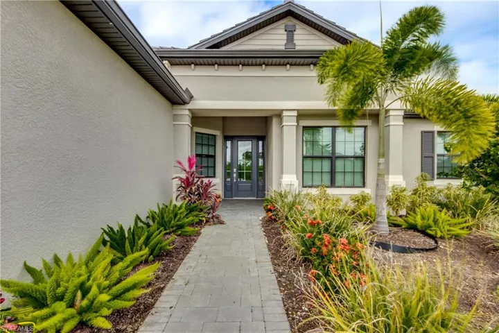 Entrance to property with stucco siding