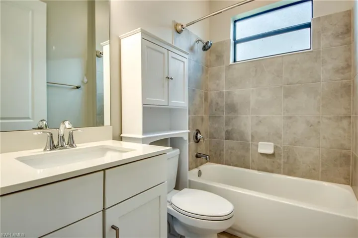 Bathroom with shower / bathtub combination and vanity