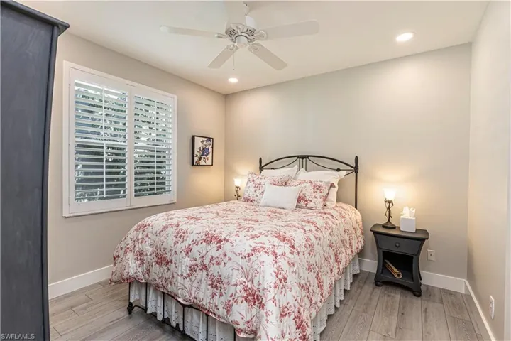 Bedroom with wood finished floors, baseboards, recessed lighting, and a ceiling fan