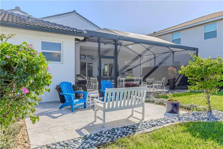 View of patio / terrace with a lanai and a fire pit