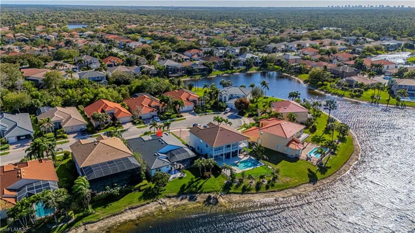 Aerial perspective of suburban area with a nearby body of water