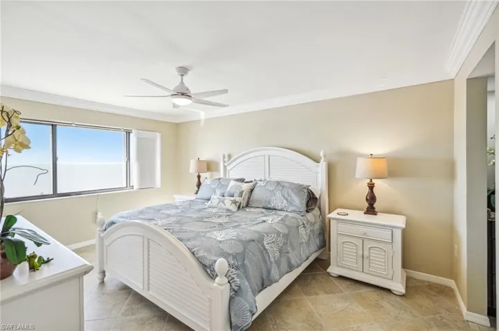 Bedroom featuring ceiling fan and ornamental molding