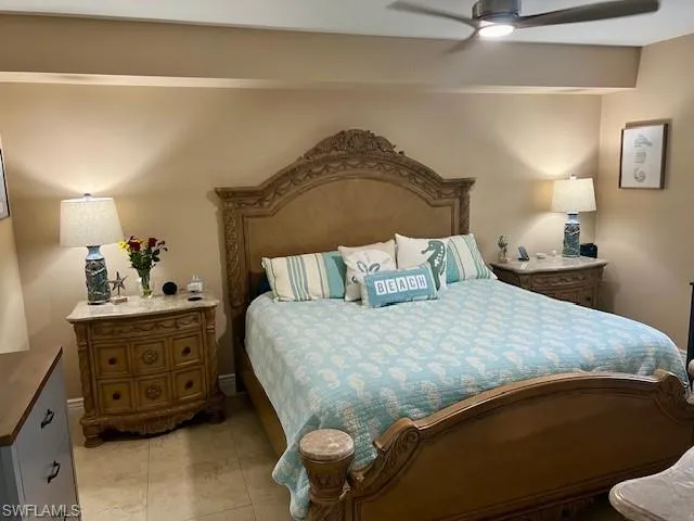 Spacious Owners Bedroom with tile floors.  Bed, nightstands, dresser/mirror and TV is being sold with the home. Bedding and linens do not convey.