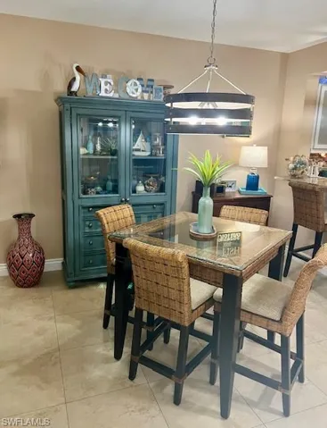Spacious dining room, with new chandelier.  Dining Room table, chairs, barstools, and curio do not convey.