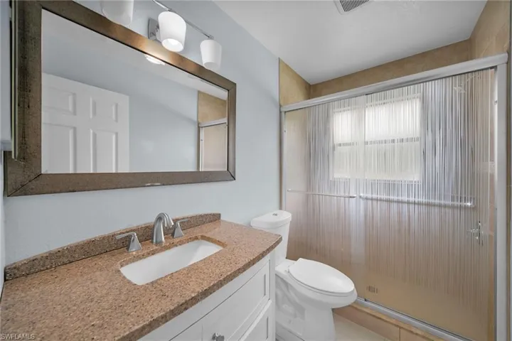 Bathroom with vanity and a shower stall