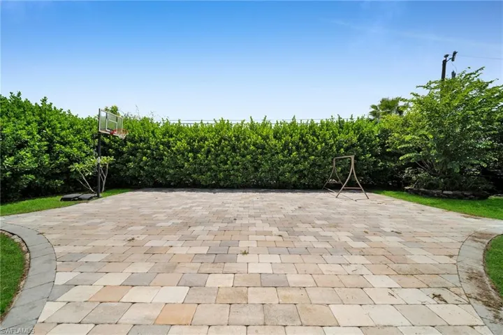 View of basketball court with a patio area