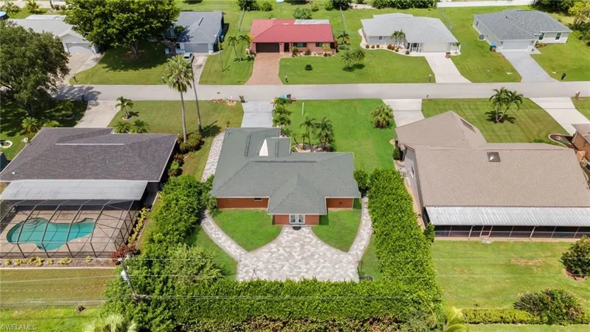 Aerial perspective of suburban area with a pool