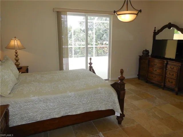 Tiled bedroom with access to outside