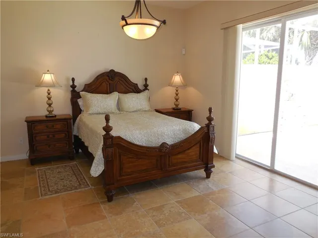 Tiled bedroom featuring access to exterior