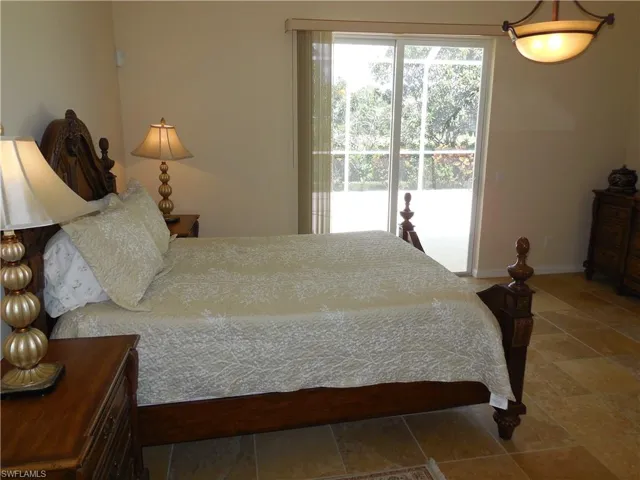 Tiled bedroom featuring access to exterior