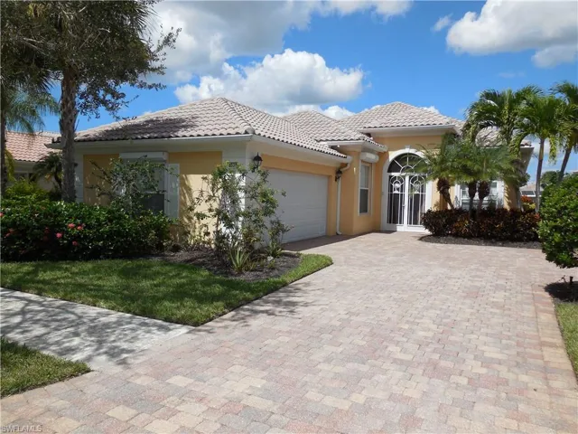 Mediterranean / spanish home featuring a garage