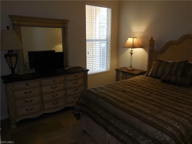 Bedroom featuring dark tile patterned flooring