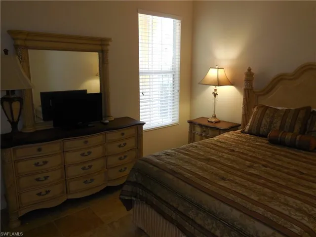 Bedroom with dark tile patterned flooring