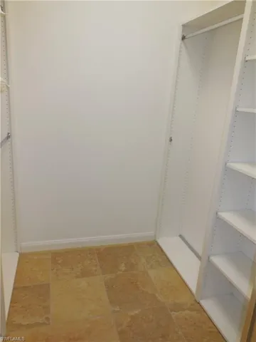 Walk in closet featuring tile patterned flooring