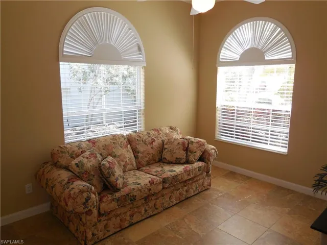 Tiled living room featuring ceiling fan