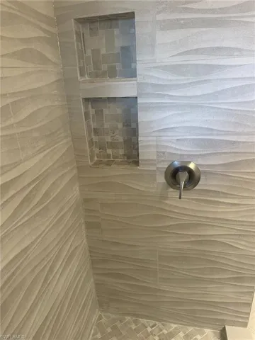 Fully remodeled primary bath offers a spa tub in this waterfront condo with new air conditioner, hot water heater, appliances, baths, and flooring is ready for you. Prentiss Pointe Condo for sale in Fort Myers Florida