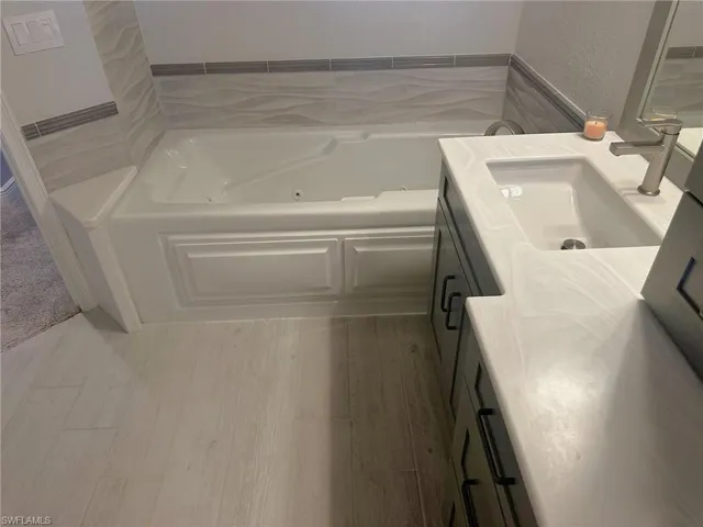 Fully remodeled primary bath offers a spa tub in this waterfront condo with new air conditioner, hot water heater, appliances, baths, and flooring is ready for you. Prentiss Pointe Condo for sale in Fort Myers Florida