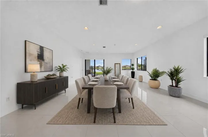 Large format tile flooring, recessed ceiling lighting, and multiple windows