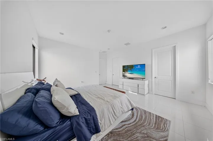 White interior walls with recessed lighting, tile flooring, and white paneled doors
