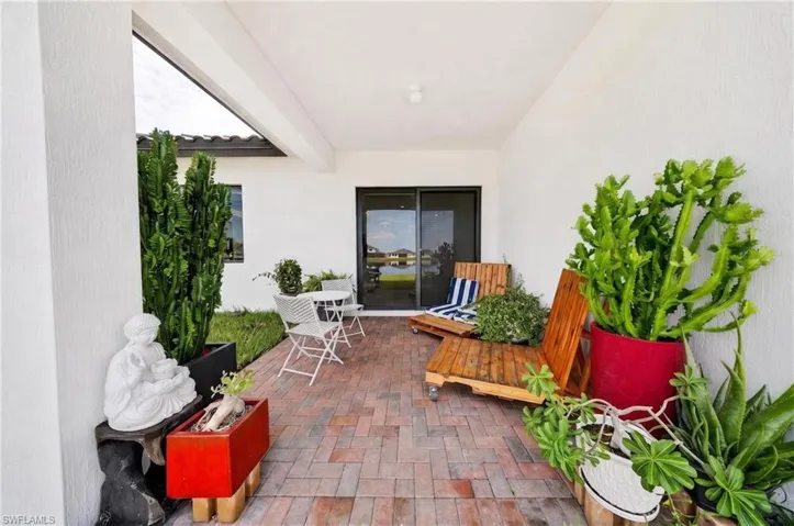 Covered patio with brick paver flooring and sliding glass door access