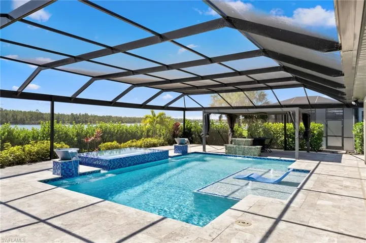 Oversized custom pool area with travertine pavers