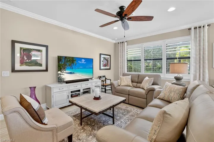 Living room featuring crown molding, ceiling fan, wood finished floors, and recessed lighting