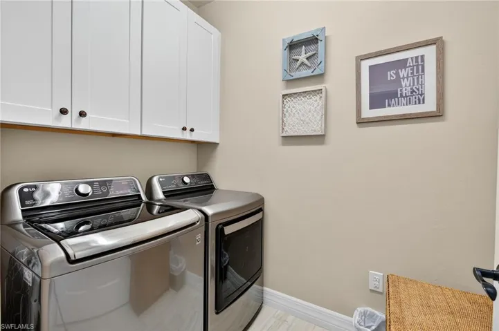 Washroom with cabinet space and separate washer and dryer