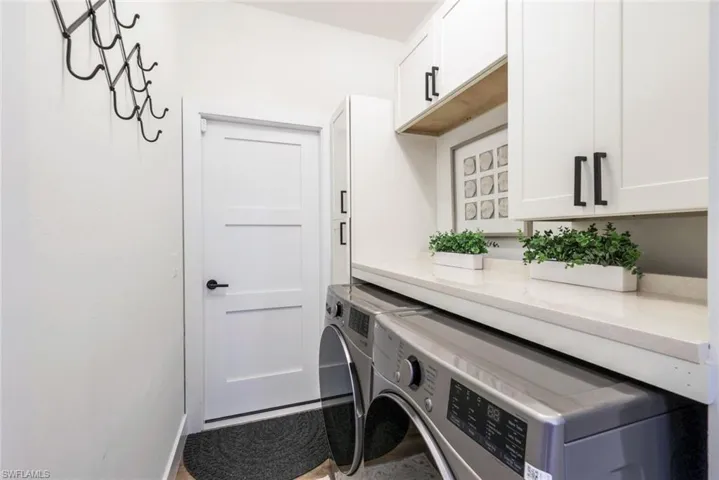 Laundry area with cabinet space and separate washer and dryer