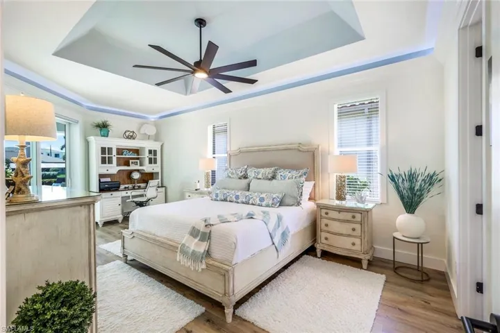Master Bedroom with accent lighting + sliders to pool deck