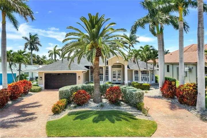 Front of home with circular block paved driveway