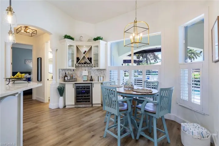 Breakfast Nook with custom built bar with wine refrigerator