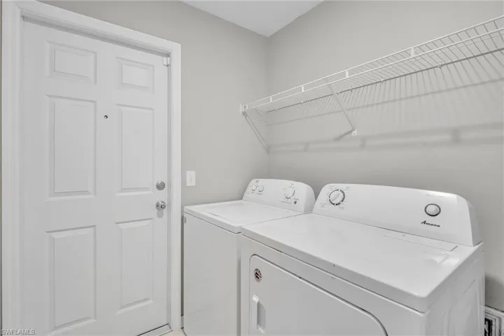 Laundry room with independent washer and dryer and laundry area