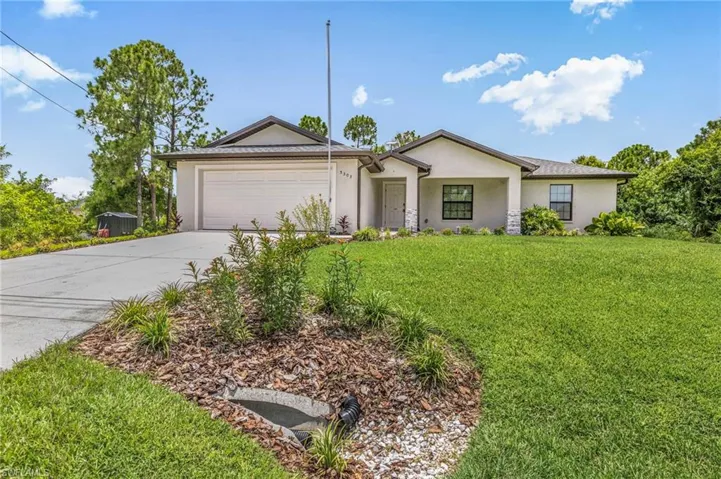 Single story home featuring stucco siding, concrete driveway, a front lawn, and an attached garage