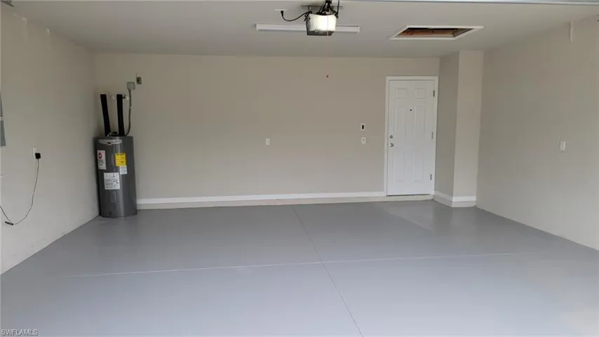 Garage with water heater and a garage door opener