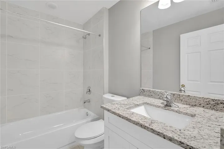 Full bath with vanity, toilet, and bathing tub / shower combination