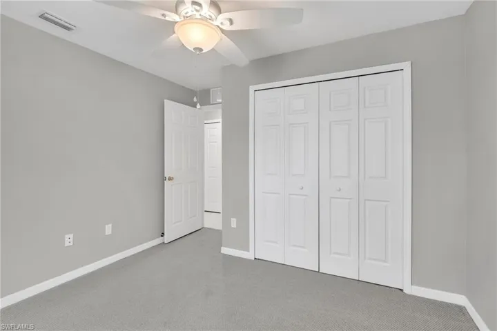 Unfurnished bedroom featuring visible vents, carpet floors, and baseboards