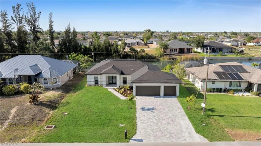 Aerial perspective of suburban area with a nearby body of water