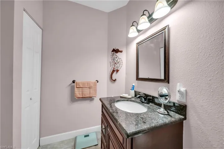 Bathroom with vanity and a closet