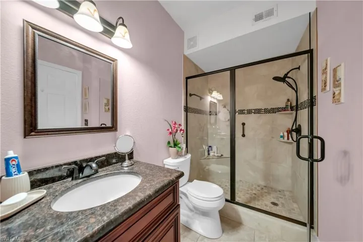 Bathroom with vanity and a stall shower