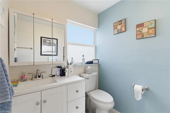 Bathroom featuring vanity and a textured wall