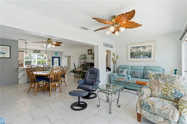 Living room featuring a ceiling fan and light tile patterned floors