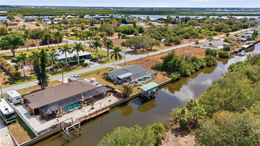 Aerial perspective of suburban area featuring a large body of water